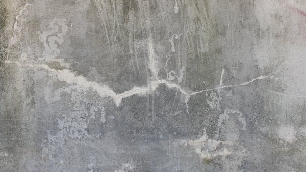 Weathered cracked concrete wall showing the type of foundation damage repaired by crack injection