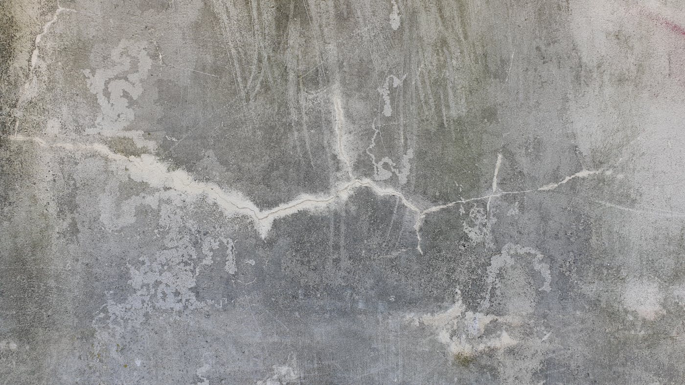 Weathered cracked concrete wall showing the type of foundation crack repaired by epoxy injection